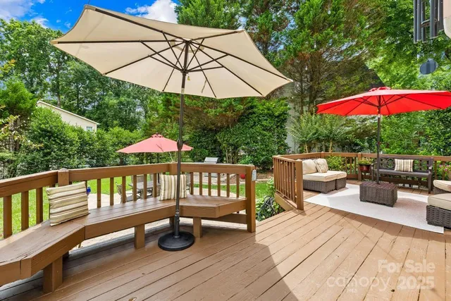 a view of a deck with furniture and umbrella