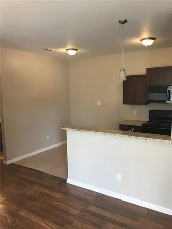a view of a room with an empty space and a ceiling fan