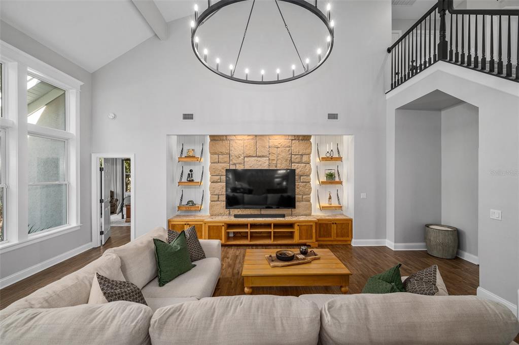 4524 Southwest 105th Drive Gainesville, FL 32608 - Photo 11 of 56 a living room with furniture a flat screen tv and a window