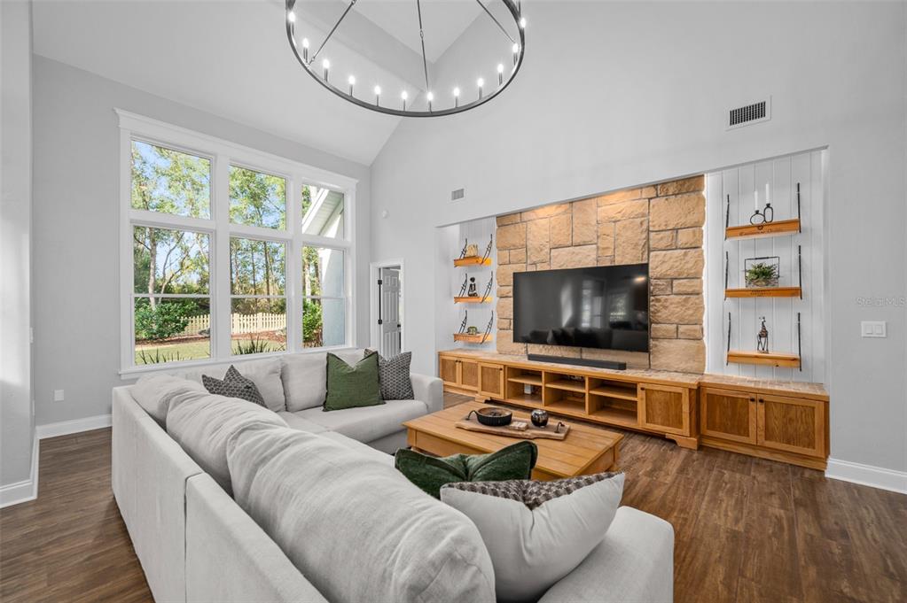 4524 Southwest 105th Drive Gainesville, FL 32608 - Photo 13 of 56 a living room with furniture and a flat screen tv