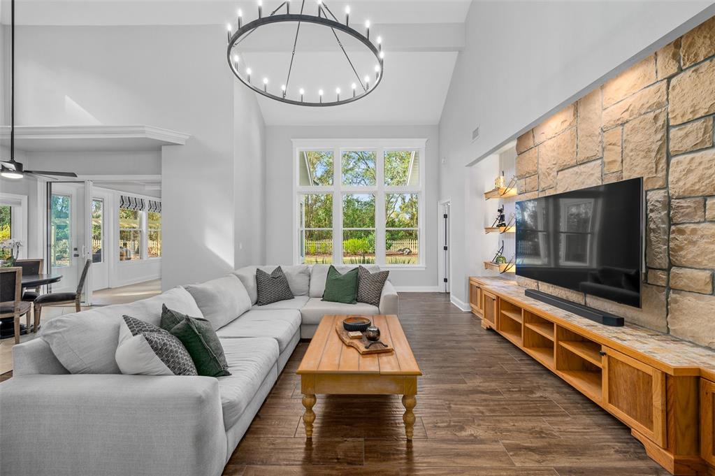 4524 Southwest 105th Drive Gainesville, FL 32608 - Photo 14 of 56 a living room with furniture a flat screen tv and a fireplace