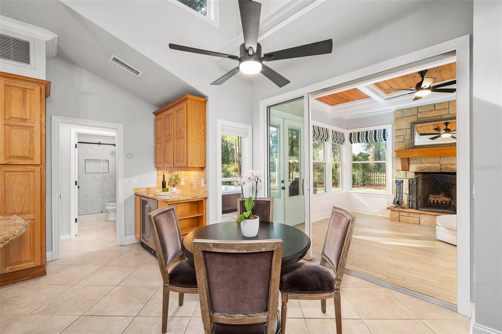 4524 Southwest 105th Drive Gainesville, FL 32608 - Photo 15 of 56 a dining room with furniture a fireplace and a chandelier