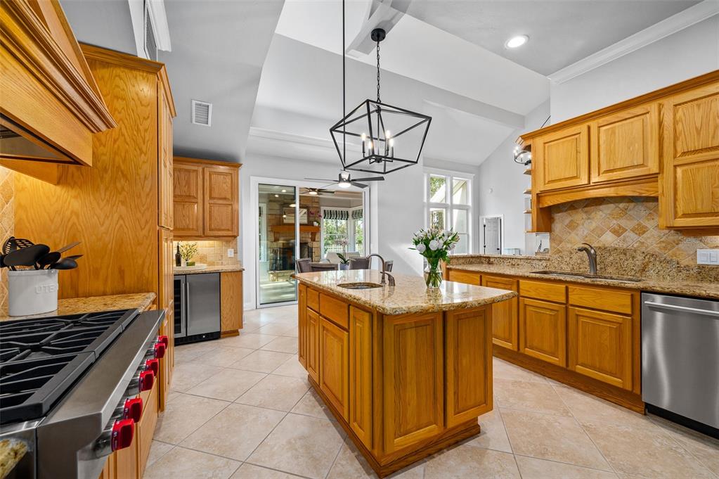 4524 Southwest 105th Drive Gainesville, FL 32608 - Photo 16 of 56 a kitchen with stainless steel appliances granite countertop a sink and a counter space