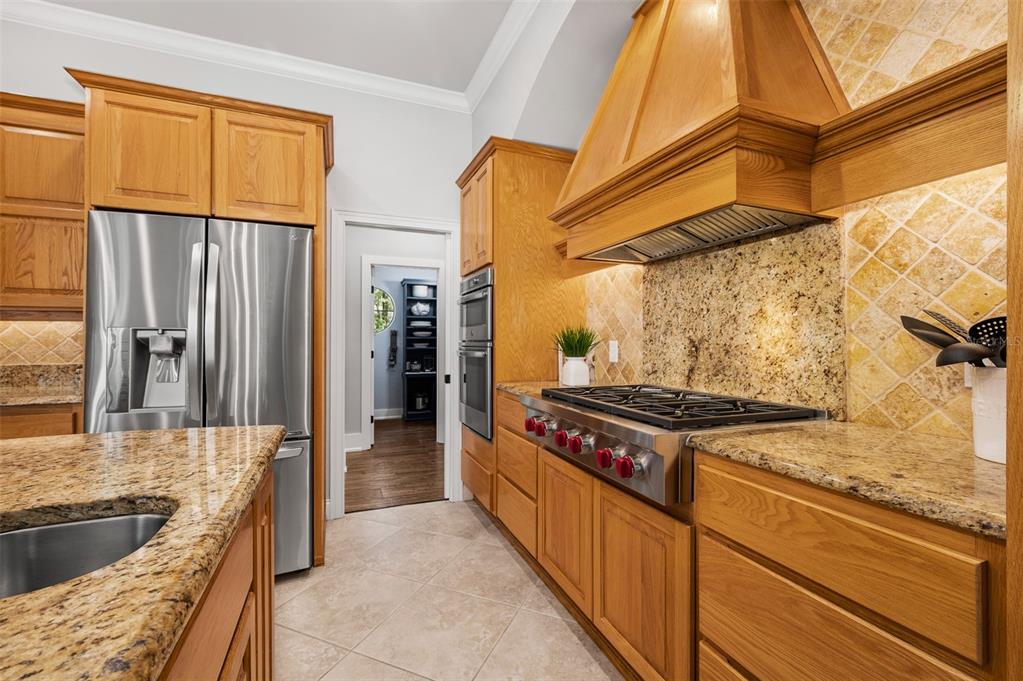 4524 Southwest 105th Drive Gainesville, FL 32608 - Photo 18 of 56 a kitchen with granite countertop a stove and a refrigerator