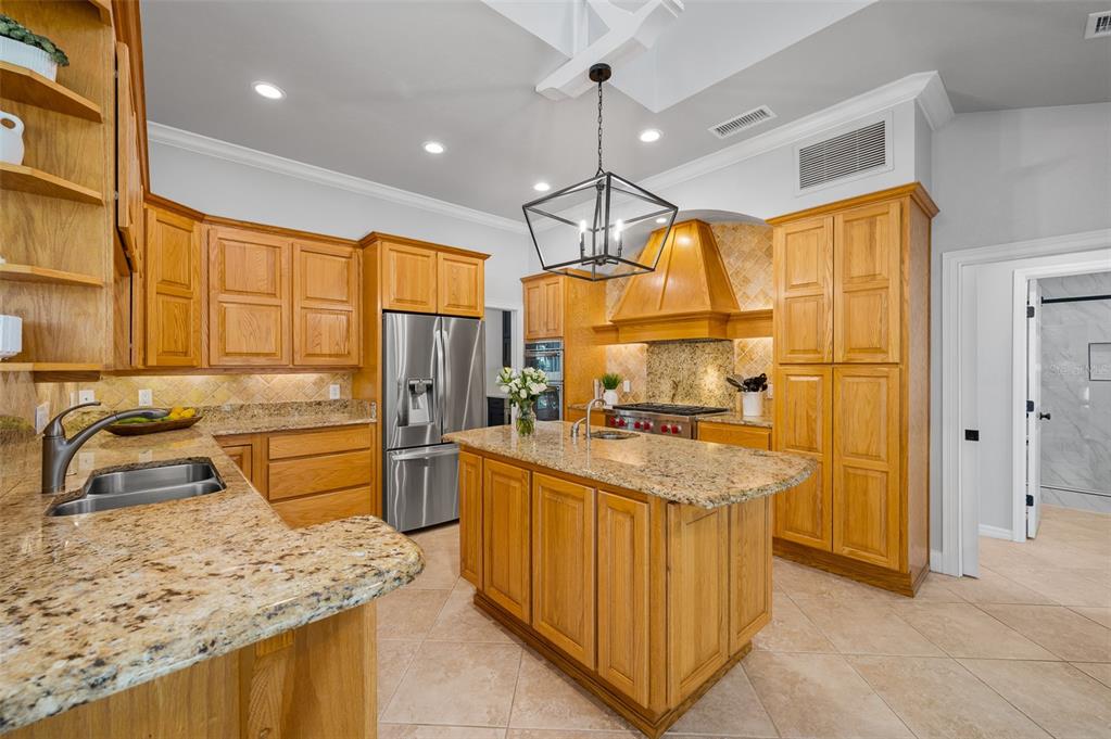 4524 Southwest 105th Drive Gainesville, FL 32608 - Photo 20 of 56 a kitchen with a sink a counter top space stainless steel appliances and cabinets