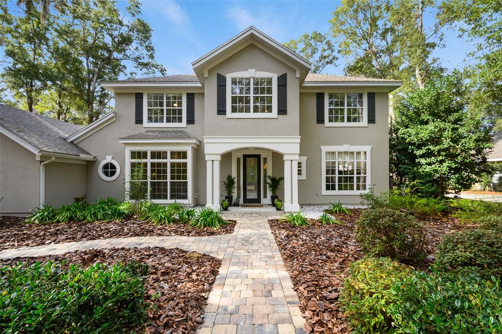 4524 Southwest 105th Drive Gainesville, FL 32608 - Photo 2 of 56 a front view of a house with garden