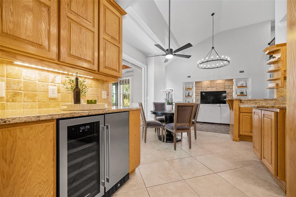 4524 Southwest 105th Drive Gainesville, FL 32608 - Photo 21 of 56 a kitchen with stainless steel appliances granite countertop a sink and dishwasher a refrigerator with wooden cabinets