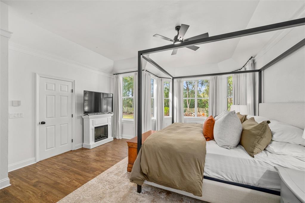 4524 Southwest 105th Drive Gainesville, FL 32608 - Photo 28 of 56 a spacious bedroom with a bed and a flat screen tv