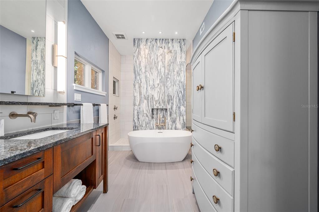 4524 Southwest 105th Drive Gainesville, FL 32608 - Photo 32 of 56 a bathroom with a tub sink and mirror