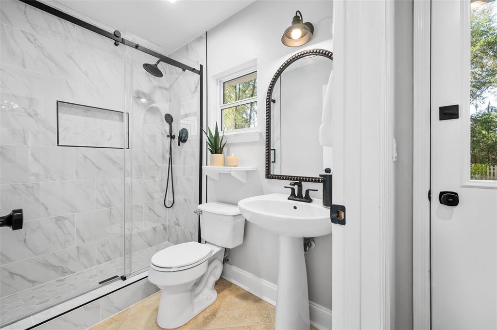 4524 Southwest 105th Drive Gainesville, FL 32608 - Photo 38 of 56 a bathroom with a toilet sink and shower