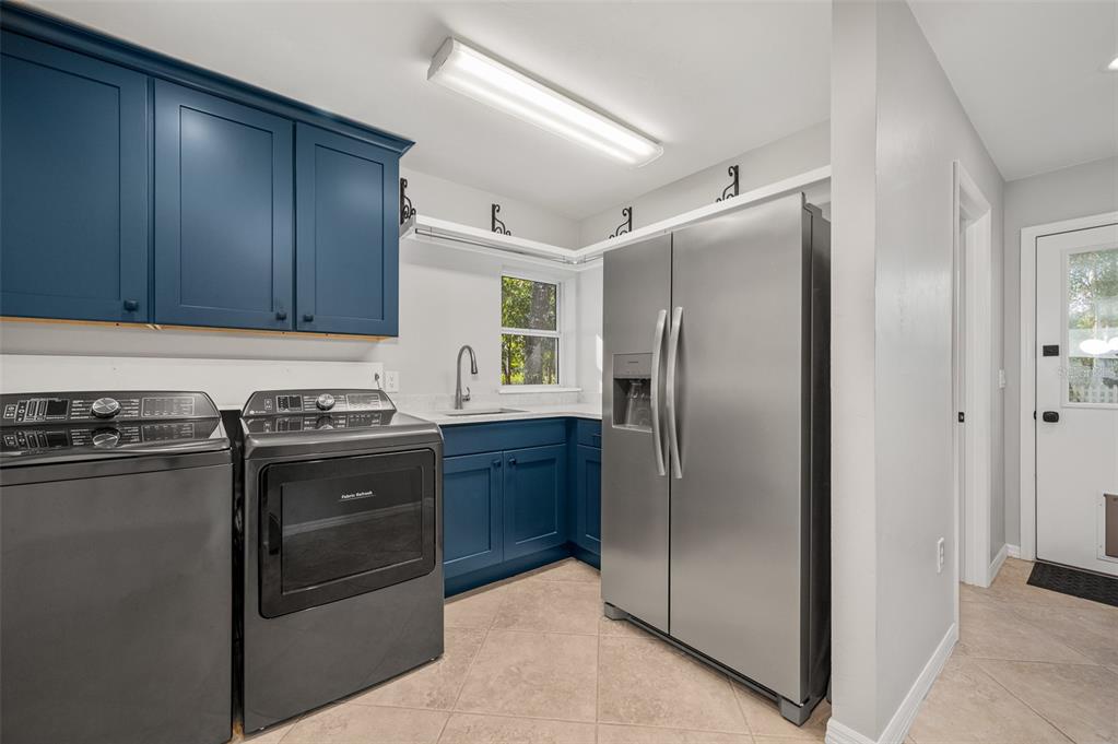 4524 Southwest 105th Drive Gainesville, FL 32608 - Photo 39 of 56 a kitchen with stainless steel appliances granite countertop a refrigerator and a stove top oven