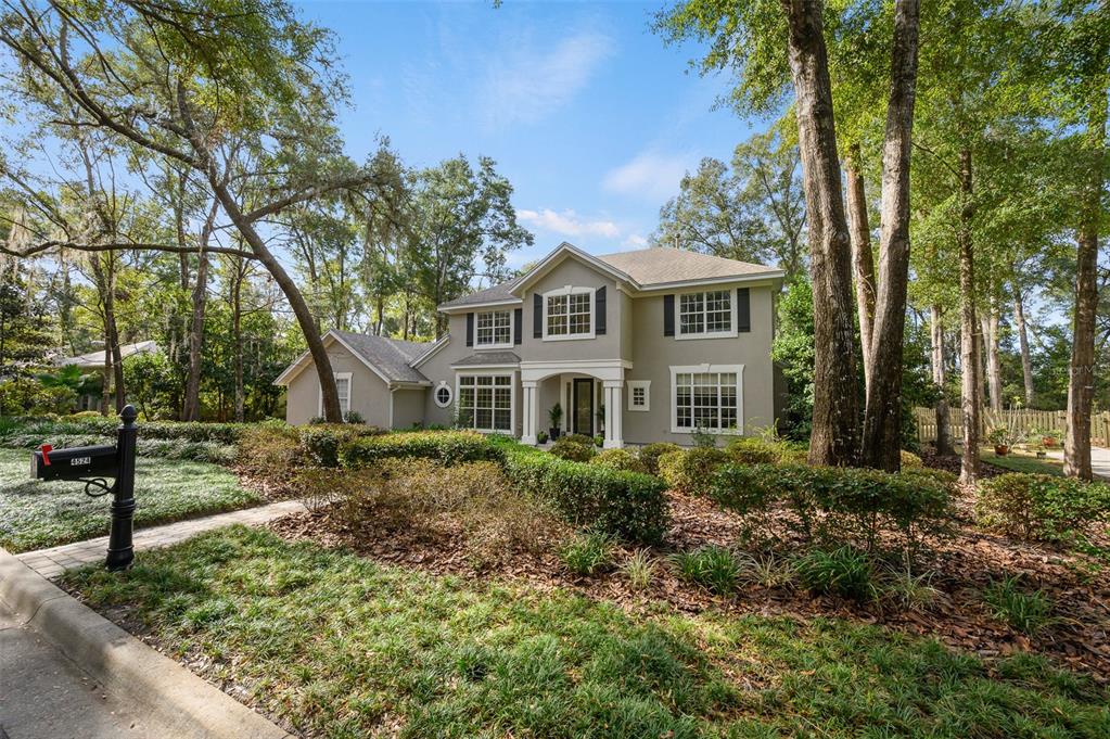4524 Southwest 105th Drive Gainesville, FL 32608 - Photo 4 of 56 a front view of a house with a garden
