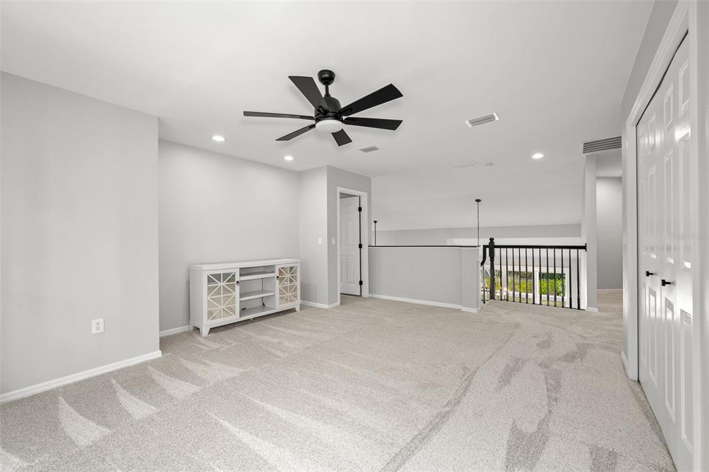 4524 Southwest 105th Drive Gainesville, FL 32608 - Photo 42 of 56 a view of an empty room with a ceiling fan