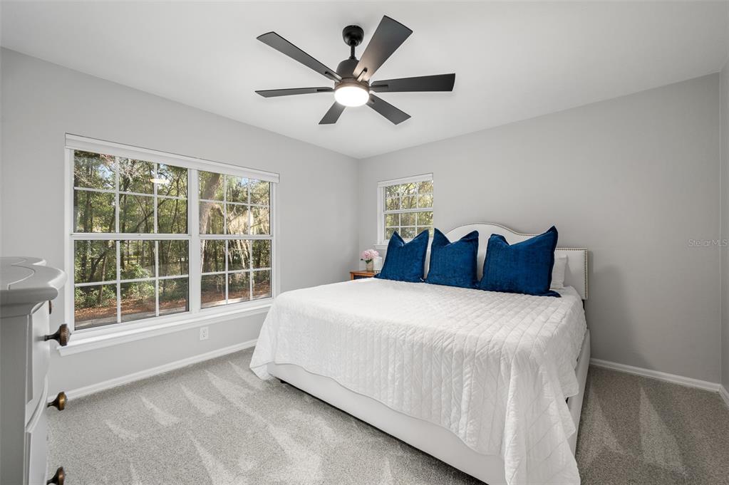 4524 Southwest 105th Drive Gainesville, FL 32608 - Photo 43 of 56 a bedroom with a large bed and a large window