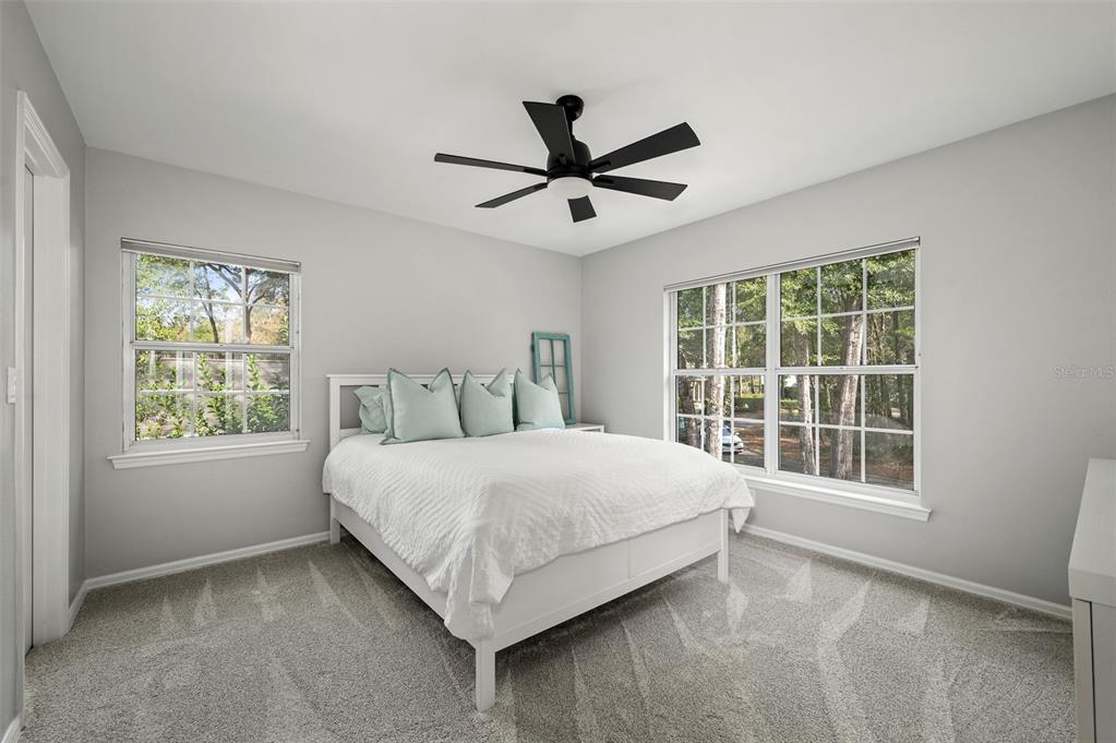 4524 Southwest 105th Drive Gainesville, FL 32608 - Photo 44 of 56 a large bed sitting in a bedroom next to a window