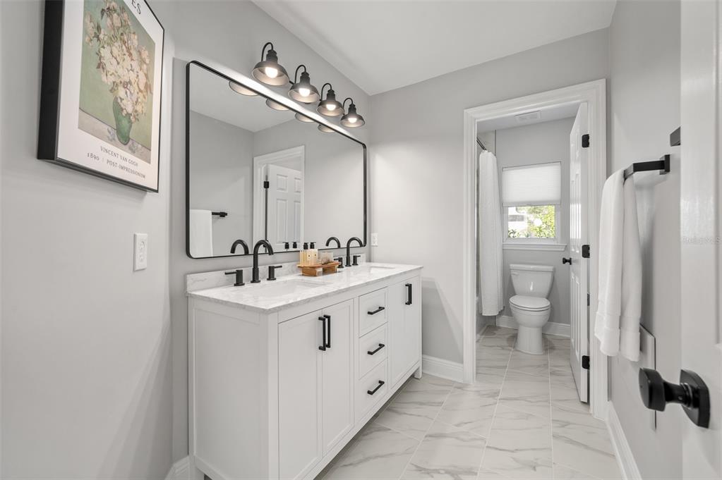 4524 Southwest 105th Drive Gainesville, FL 32608 - Photo 45 of 56 a spacious bathroom with a double vanity sink and a mirror