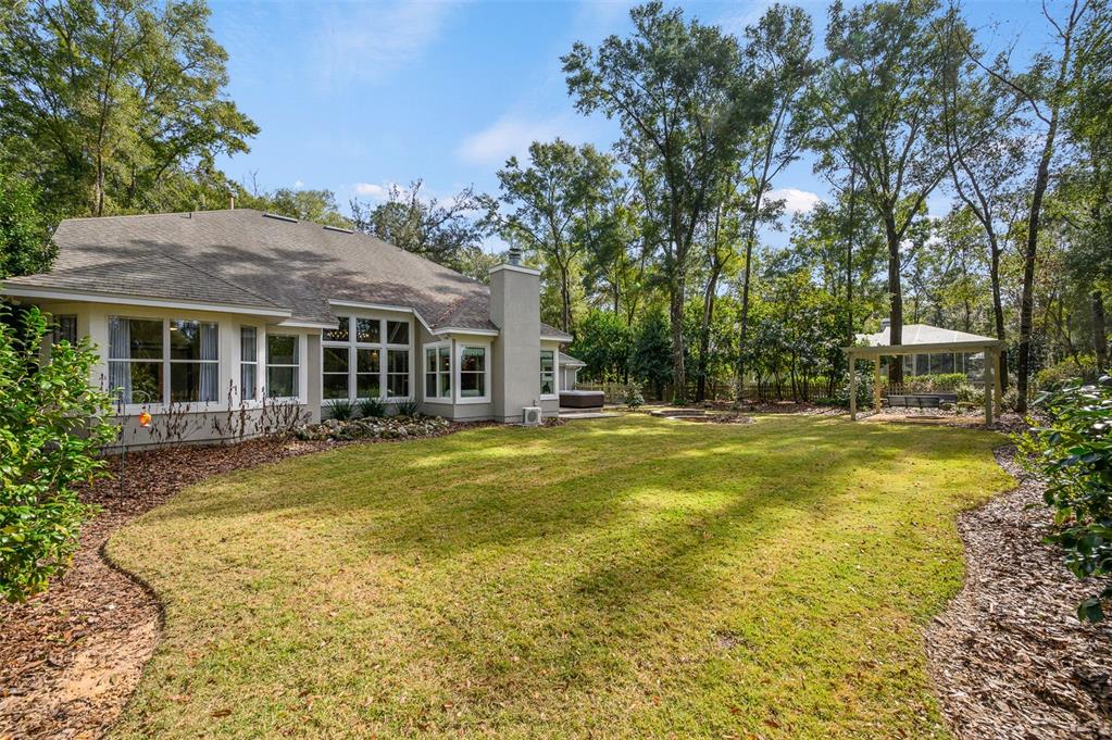 4524 Southwest 105th Drive Gainesville, FL 32608 - Photo 49 of 56 a view of a house with a swimming pool