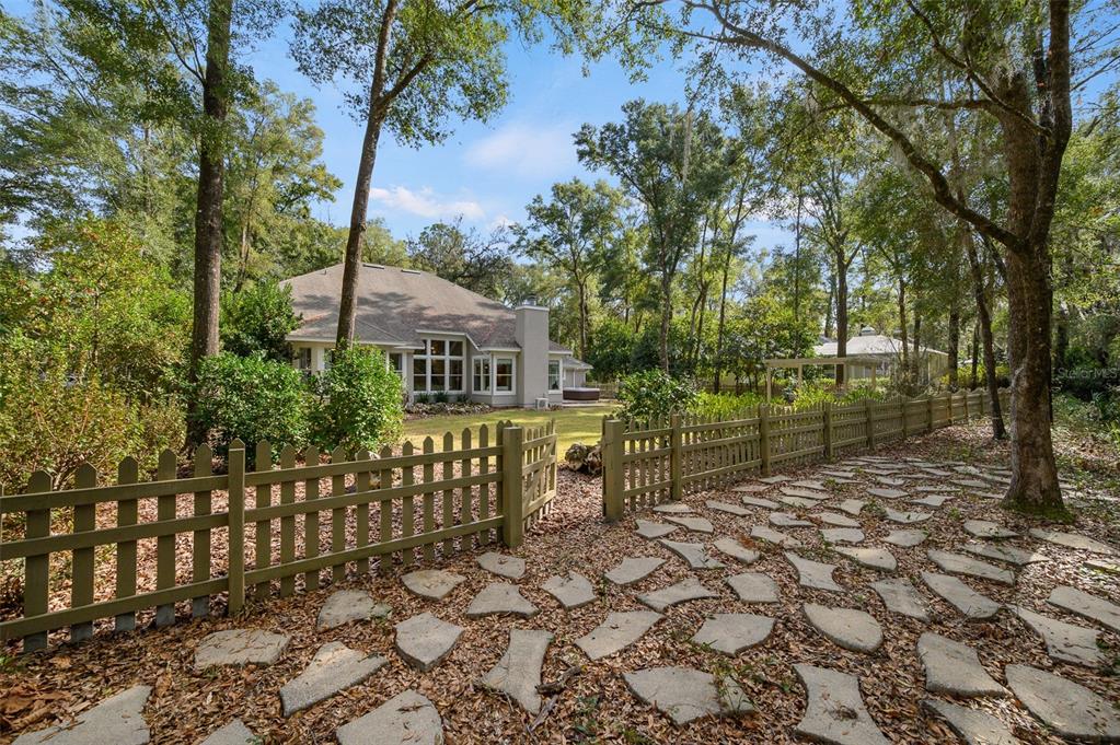 4524 Southwest 105th Drive Gainesville, FL 32608 - Photo 52 of 56 a front view of a house with a garden