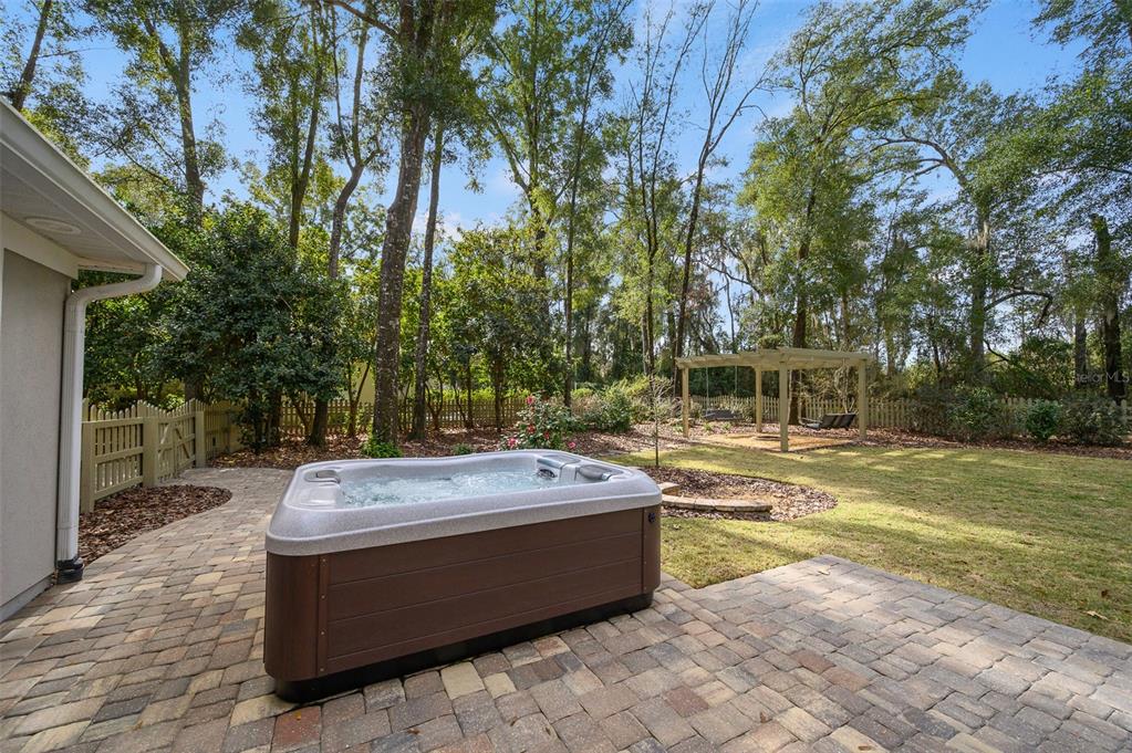 4524 Southwest 105th Drive Gainesville, FL 32608 - Photo 53 of 56 a view of a swimming pool with a sitting area