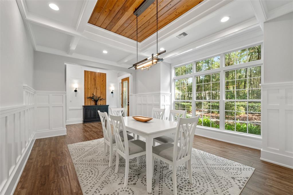 4524 Southwest 105th Drive Gainesville, FL 32608 - Photo 6 of 56 a dining room with furniture and a floor to ceiling window