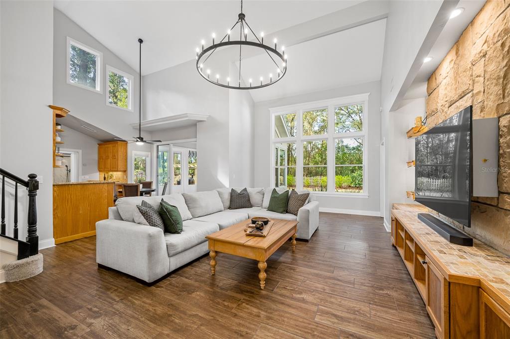 4524 Southwest 105th Drive Gainesville, FL 32608 - Photo 9 of 56 a living room with furniture a table and a large window