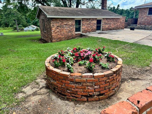 4912 Old Gordon Road Dry Branch, GA 31020 - Photo 23 of 32 a view of a house with a yard and potted plants