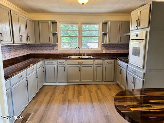 4912 Old Gordon Road Dry Branch, GA 31020 - Photo 3 of 32 a kitchen with wooden floors and white appliances