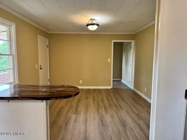 a view of kitchen with wooden floor and window