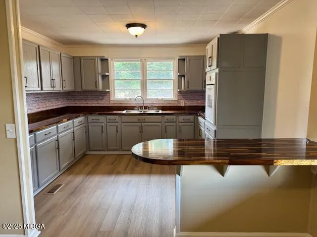 a kitchen with kitchen island granite countertop a sink a counter space and stainless steel appliances