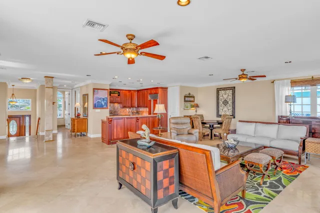 a view of a dining room with furniture a chandelier and wooden floor