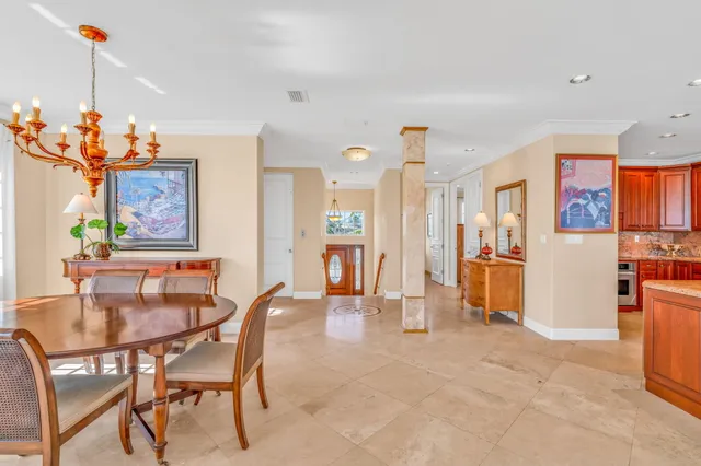 a front view of a building with outdoor seating and plants