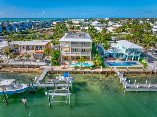 a front view of a house with a yard and a garage