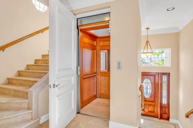a bedroom with a large bed and a chandelier