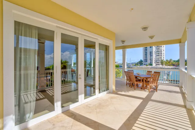 a bedroom with a bed and a lamp on dresser