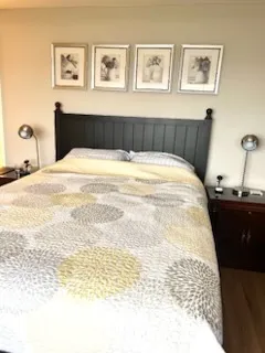 a bedroom with bed and wooden floor