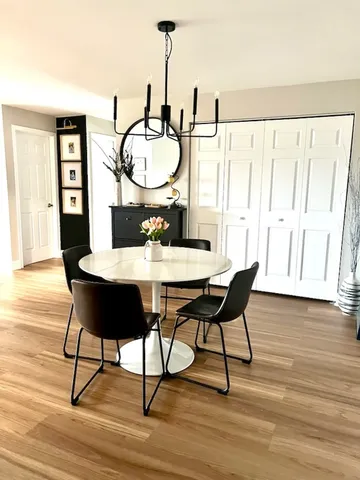 a view of a dining room with furniture window and wooden floor