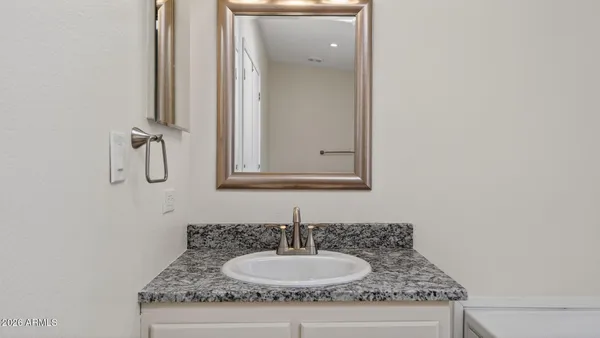 a bathroom with a sink and a mirror