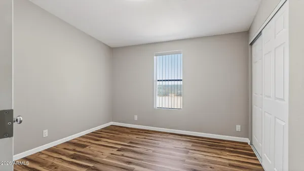 a view of an empty room and wooden floor