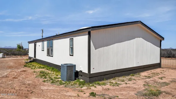 a view of room with window and wooden floor