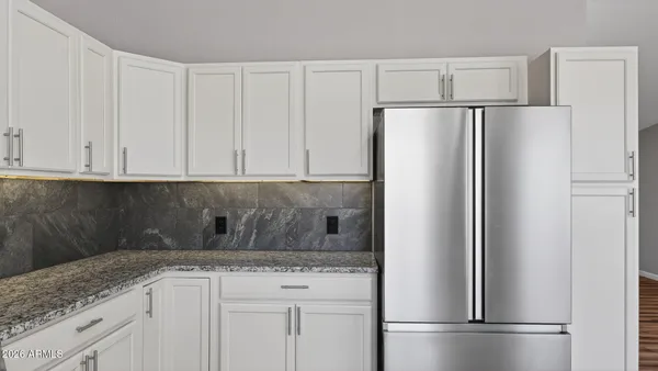 a kitchen with appliances cabinets and a counter space