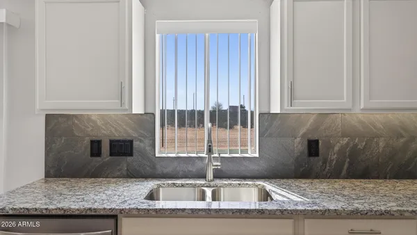 a kitchen with granite countertop a sink and a window