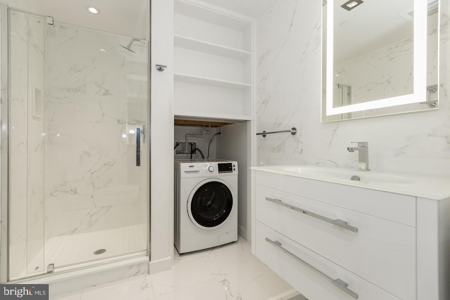 1602 Sansom Street, Unit 2 Philadelphia, PA 19103 - Photo 14 of 18 a utility room with sink dryer and washer