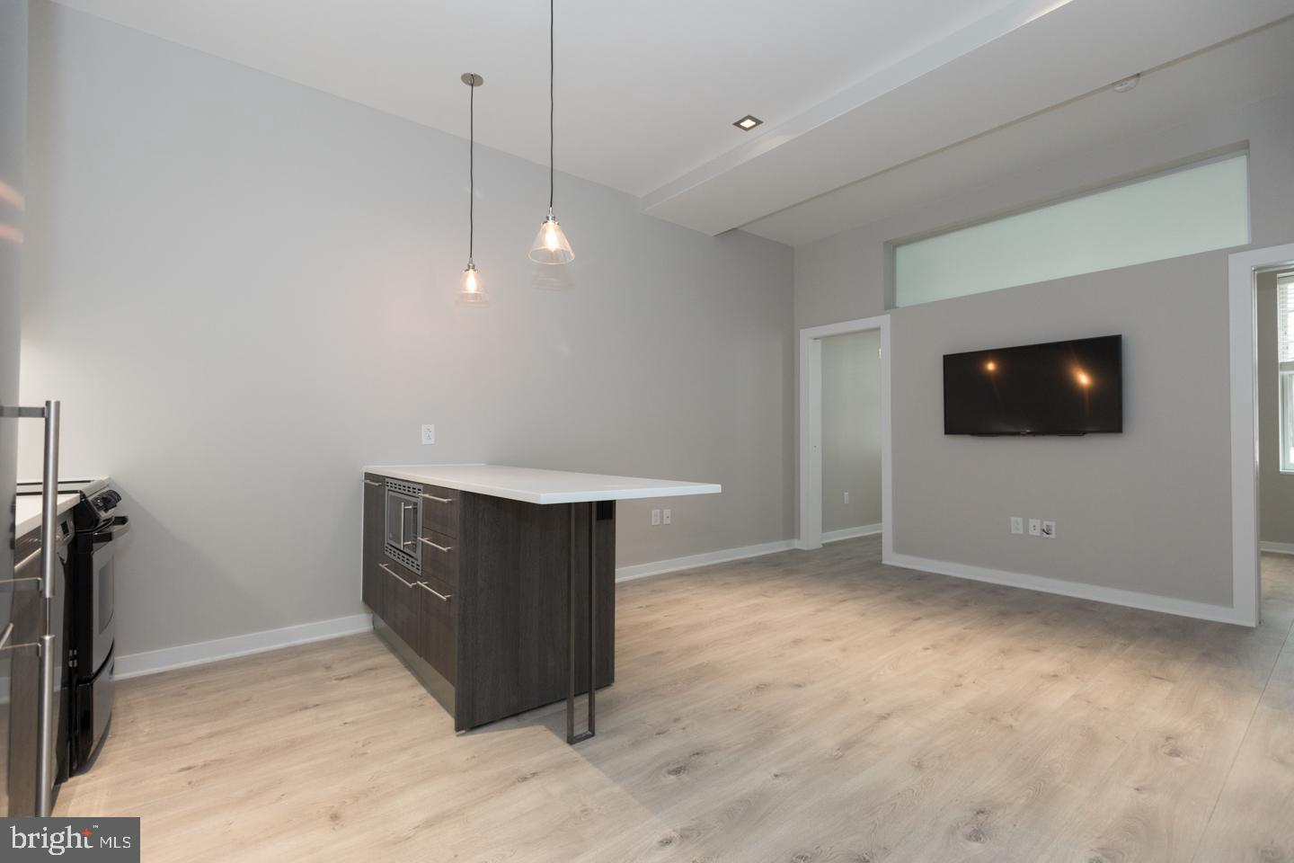 1602 Sansom Street, Unit 2 Philadelphia, PA 19103 - Photo 5 of 18 a view of an empty room and room with a flat screen tv