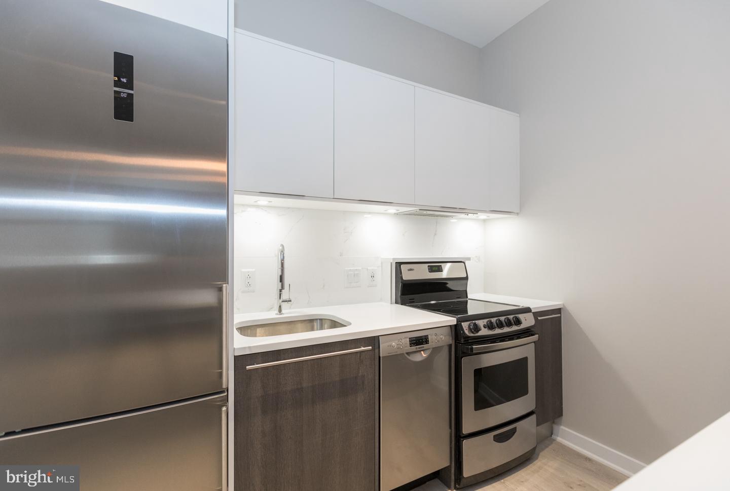 1602 Sansom Street, Unit 2 Philadelphia, PA 19103 - Photo 7 of 18 a kitchen with appliances and cabinets