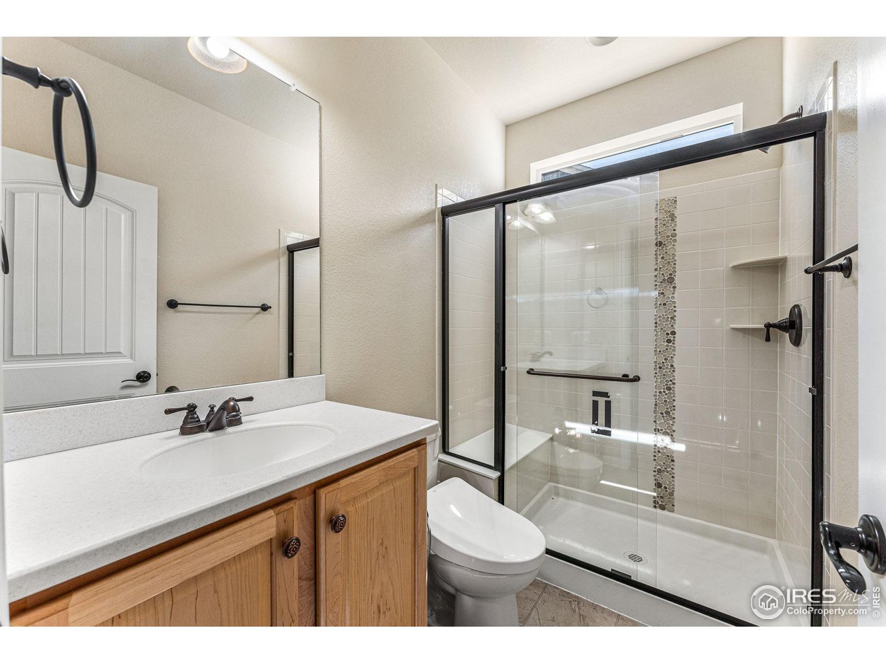 5101 Eagan Circle Longmont, CO 80503 - Photo 17 of 39 a bathroom with a sink vanity mirror and toilet