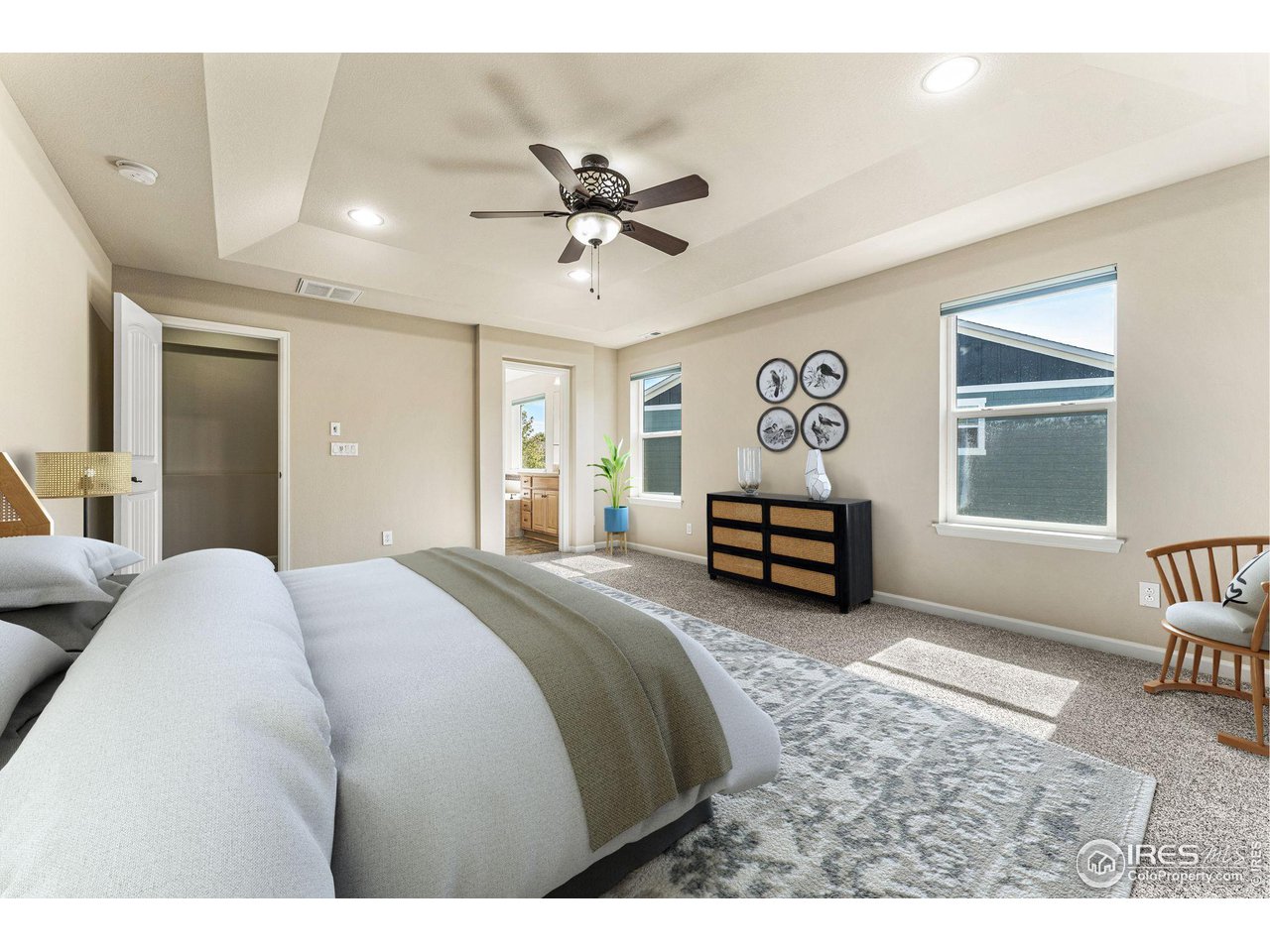 5101 Eagan Circle Longmont, CO 80503 - Photo 19 of 39 a spacious bedroom with a bed a chandelier and a window