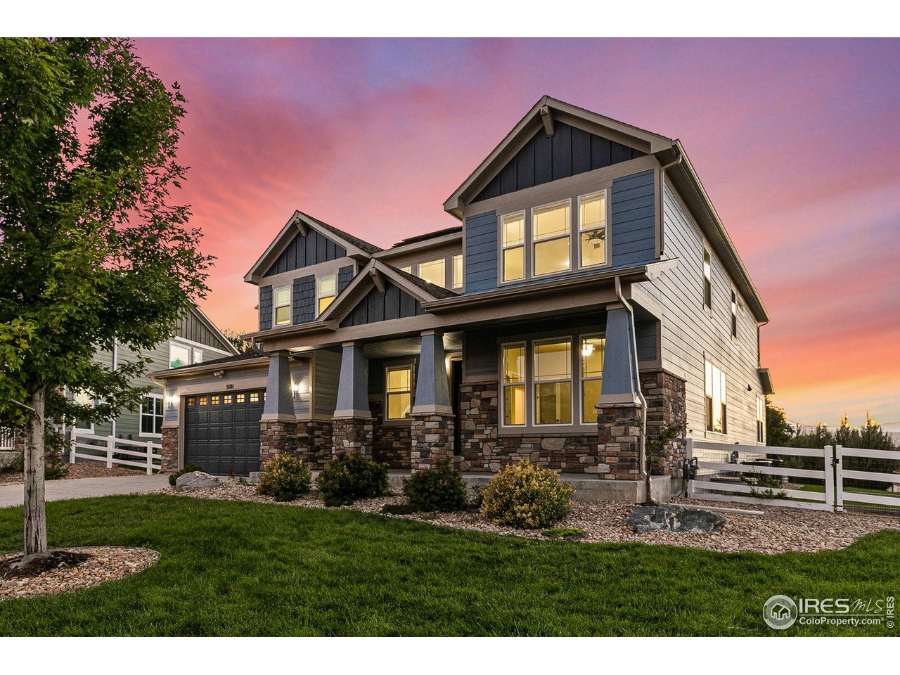 5101 Eagan Circle Longmont, CO 80503 - Photo 2 of 39 a front view of a house with a yard
