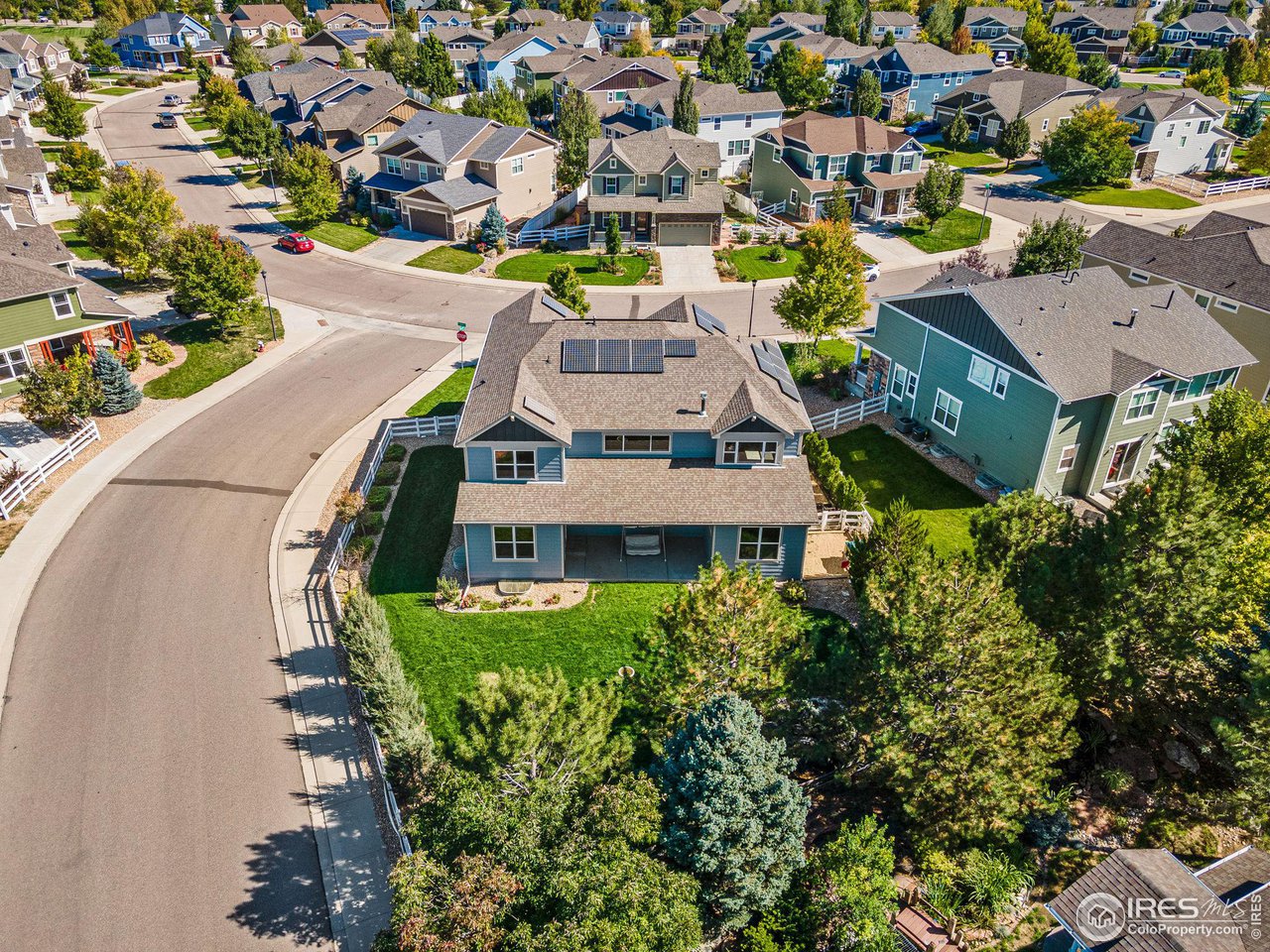 5101 Eagan Circle Longmont, CO 80503 - Photo 36 of 39 an aerial view of a house with a yard and lake view