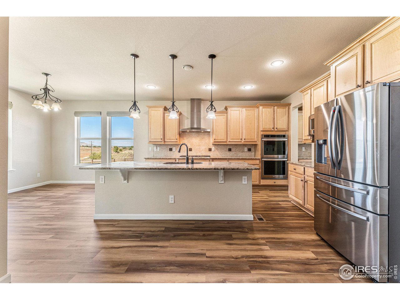 5101 Eagan Circle Longmont, CO 80503 - Photo 8 of 39 a view of kitchen with kitchen island white cabinets and stainless steel appliances