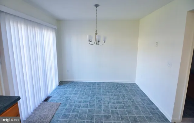 a view of a room with a door and a window